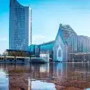 blue and white concrete building near body of water during daytime