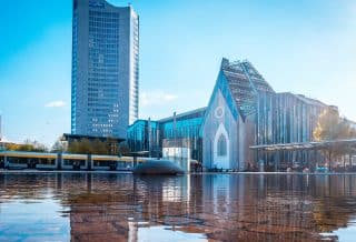 blue and white concrete building near body of water during daytime